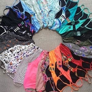 A bunch of one piece swimsuits